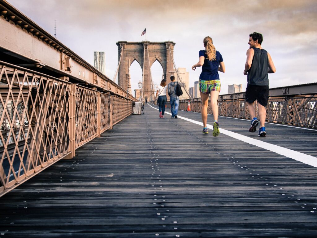 man and woman running to burn fat