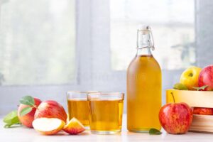Apple cider vinegar juice glass bottle fresh red apples