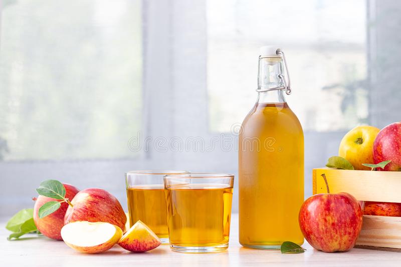 Apple cider vinegar juice glass bottle fresh red apples