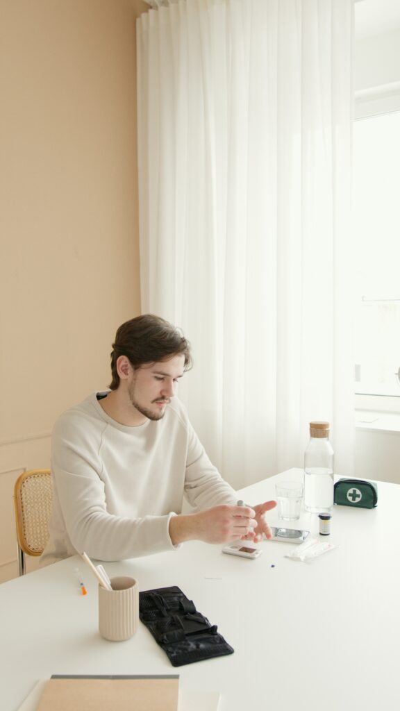 man doing blood sugar test to learn his diabetic reading